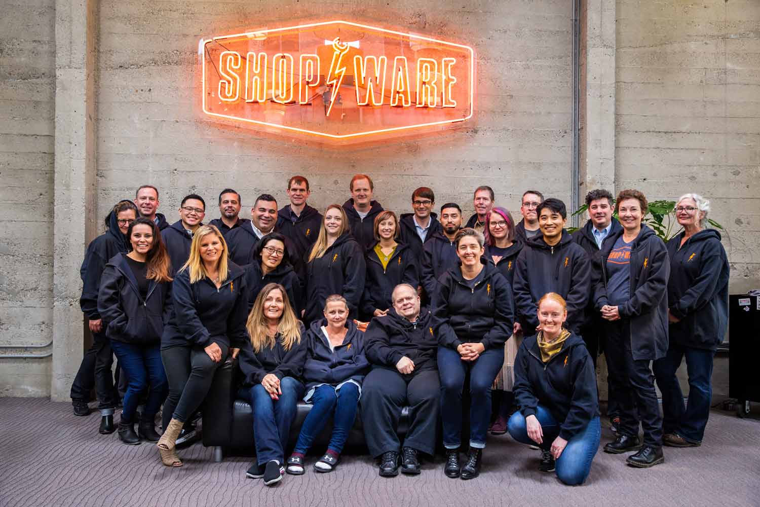 Shop-Ware Team in front of Shop-Ware sign